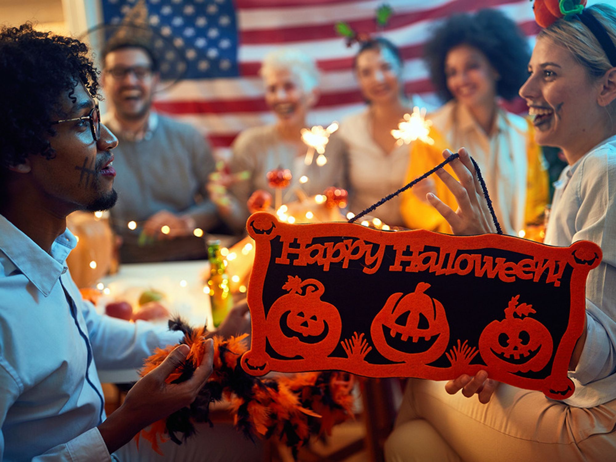 Group of coworkers dressed up in costumes and celebrating Halloween at work