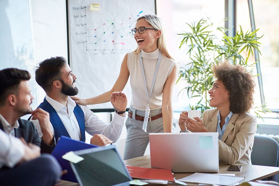 Group of happy professionals improving their careers during a work meeting