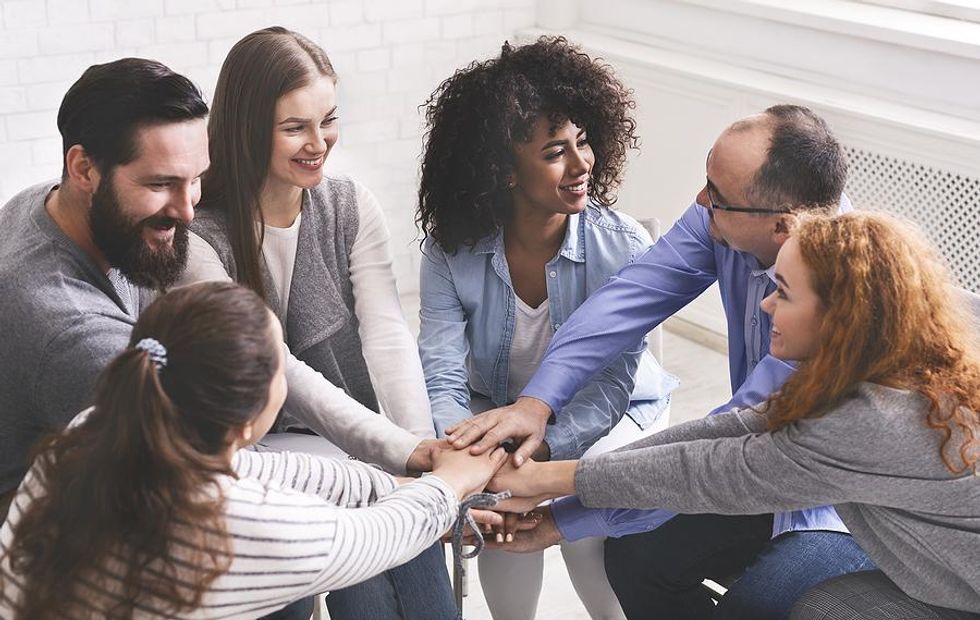 Group of people support each other
