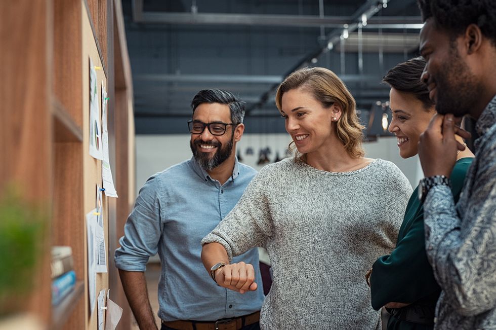 Group of professionals meet about changing the company post-COVID-19