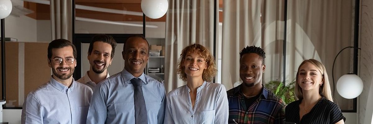 Group of professionals stand with an executive/leader