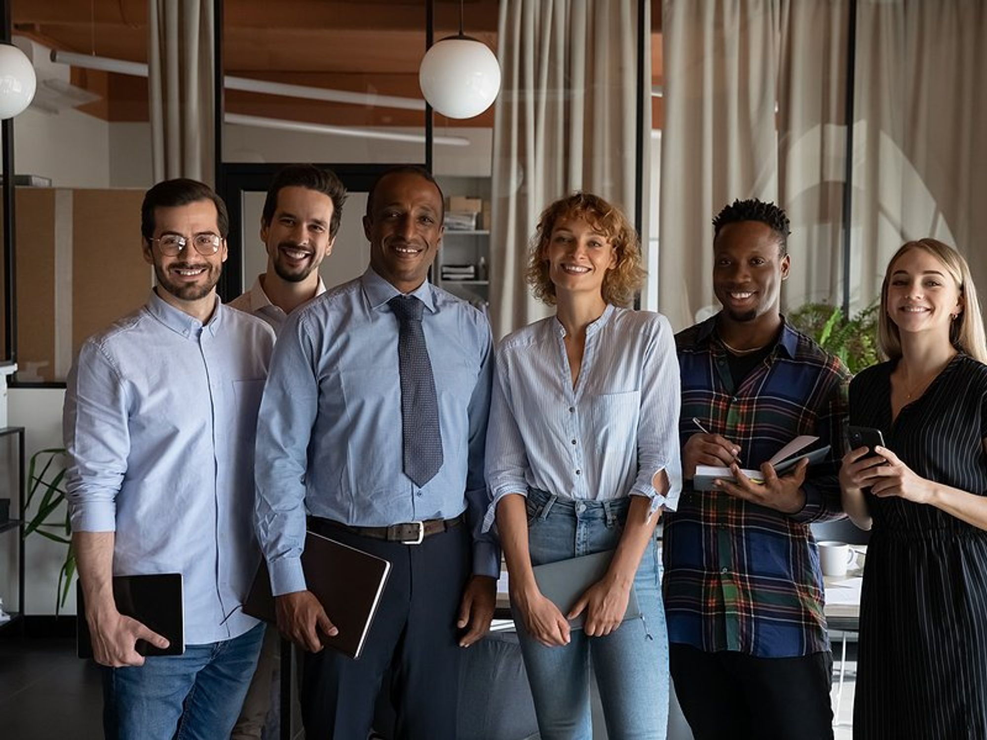 Group of professionals stand with an executive/leader