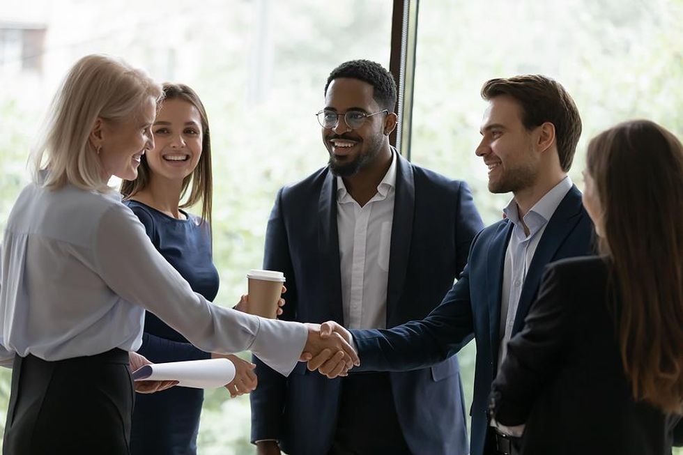 Group of professionals standing and talking at work