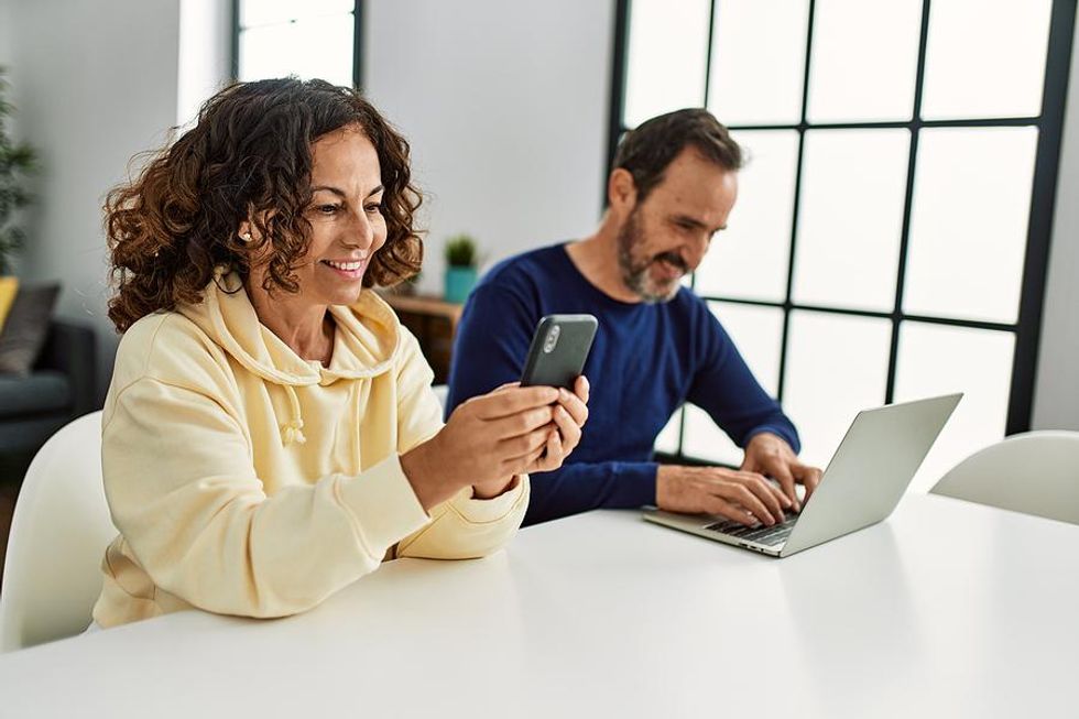 Happy couple working from home