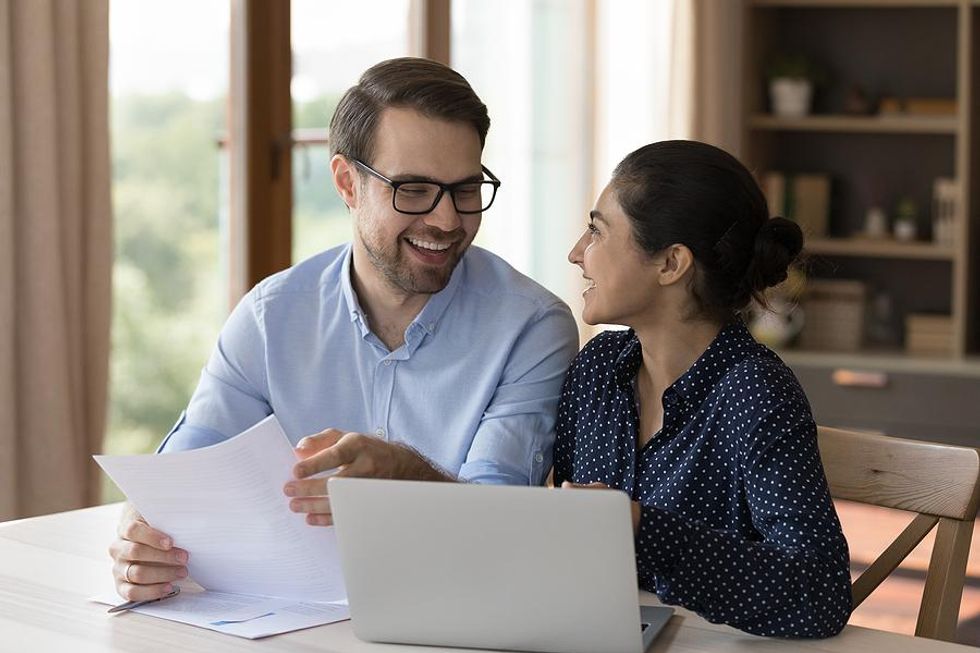 Happy coworkers talk while meeting in a healthy work environment