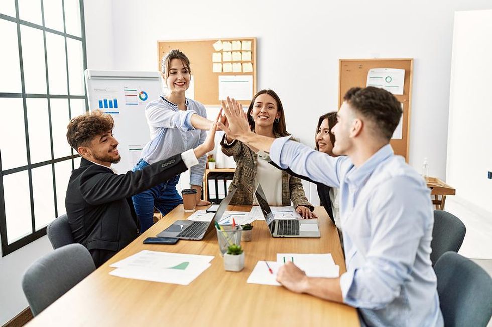 Happy employees on a successful team have a healthy work environment
