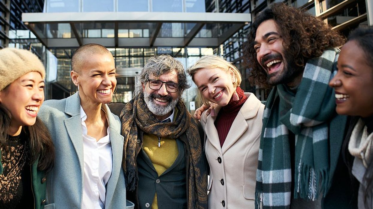 Happy employees/professionals smile while hanging out outside/at the office