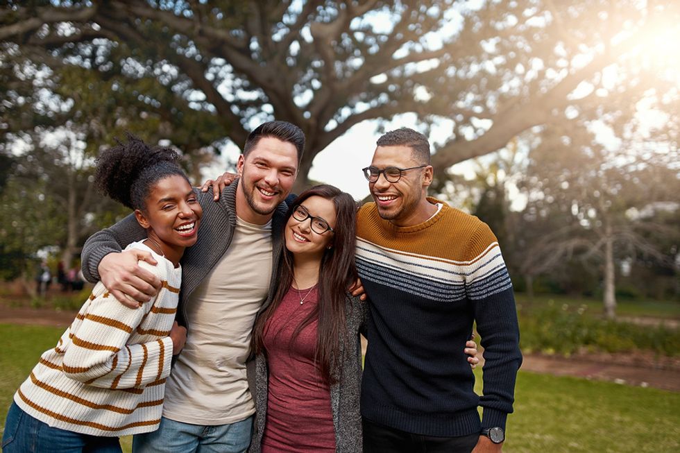 Happy group of friends hang out after prioritizing work-life balance in their lives