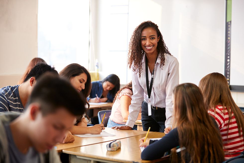 Happy high school teacher smiles because she loves her job