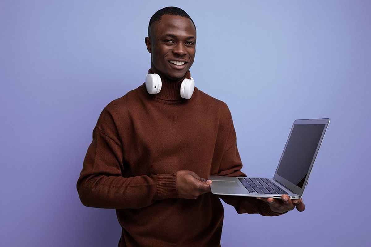 Happy job seeker holds laptop
