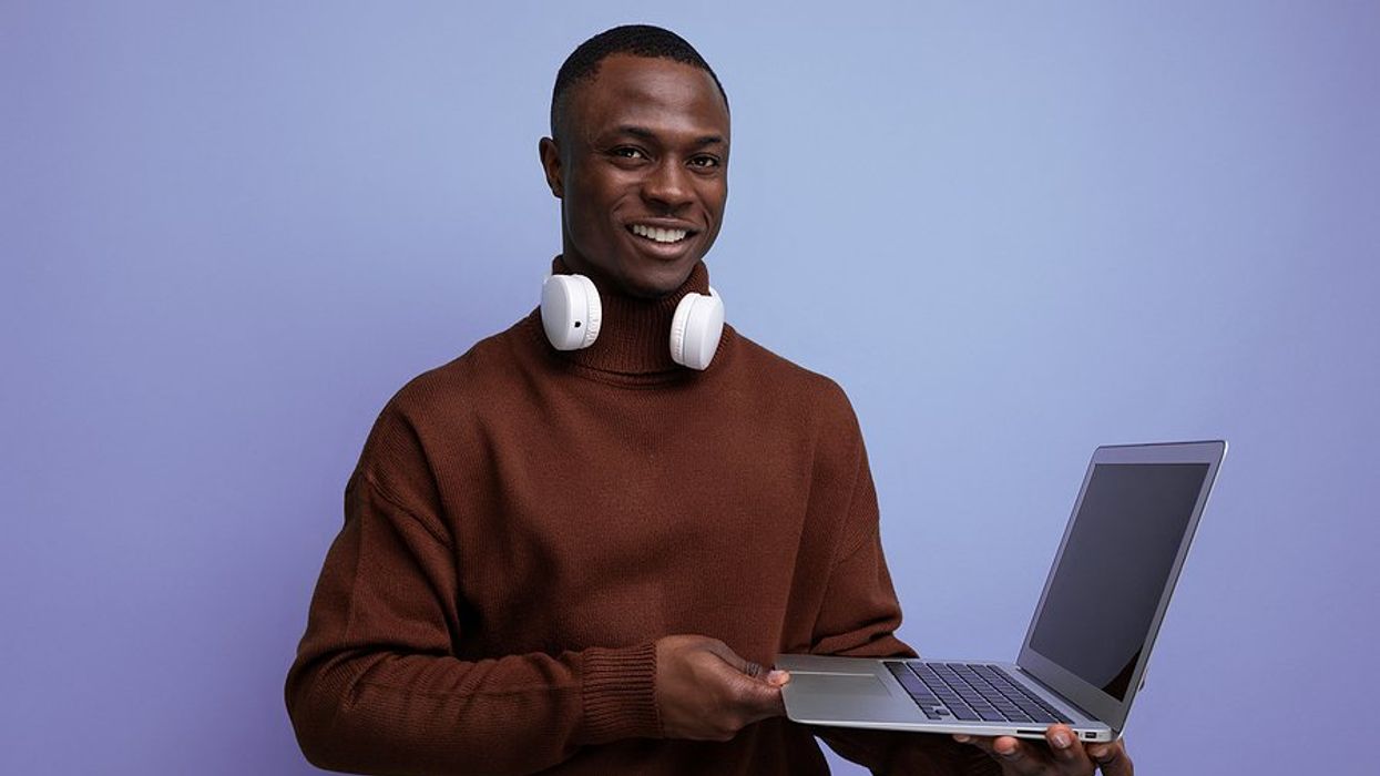 Happy job seeker holds laptop