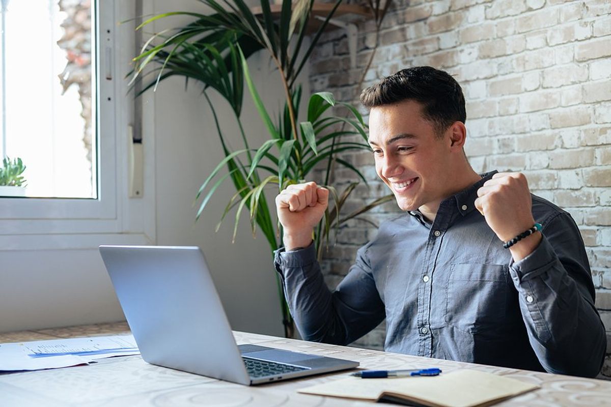 Happy man celebrates his career change success after reading motivational quotes