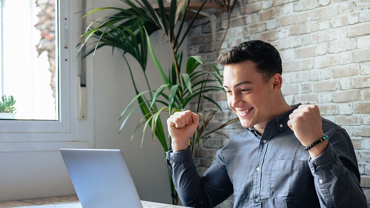 Happy man celebrates his career change success after reading motivational quotes