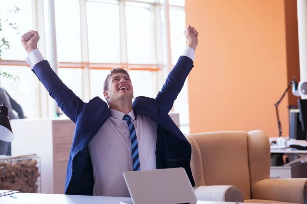 Happy man excited at work