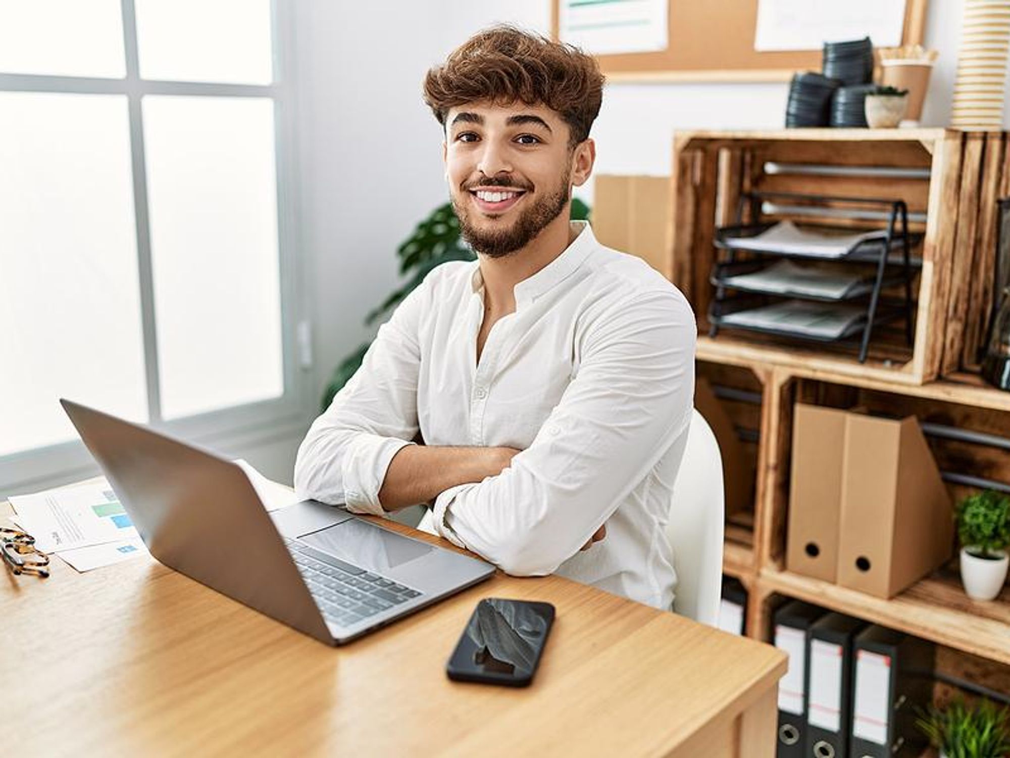 Happy man looks for a job on his laptop