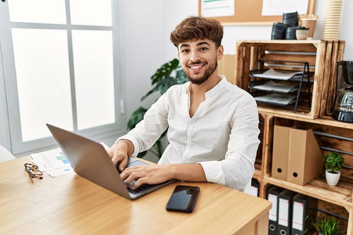 Happy man on laptop has a great day at work