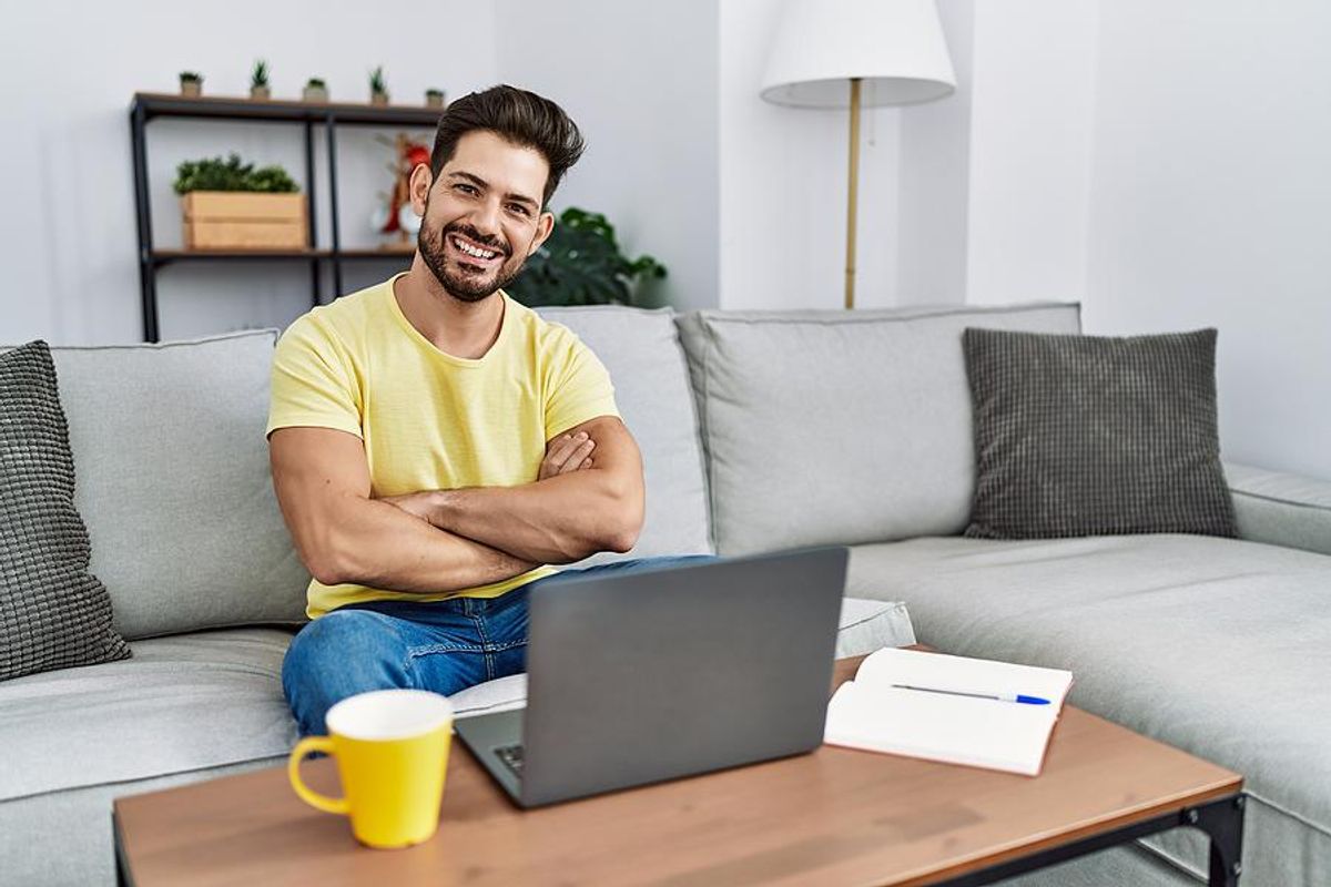 Happy man on laptop spring cleans his resume