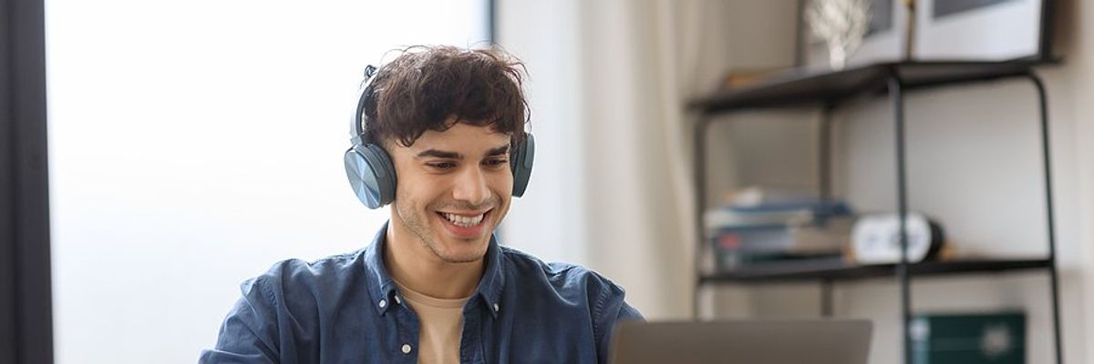 Happy man on laptop successfully changes careers