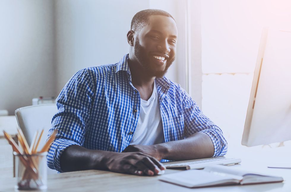 Happy man on laptop works from home