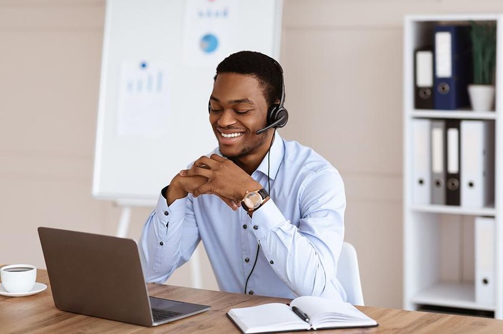 Happy man on laptop works from home