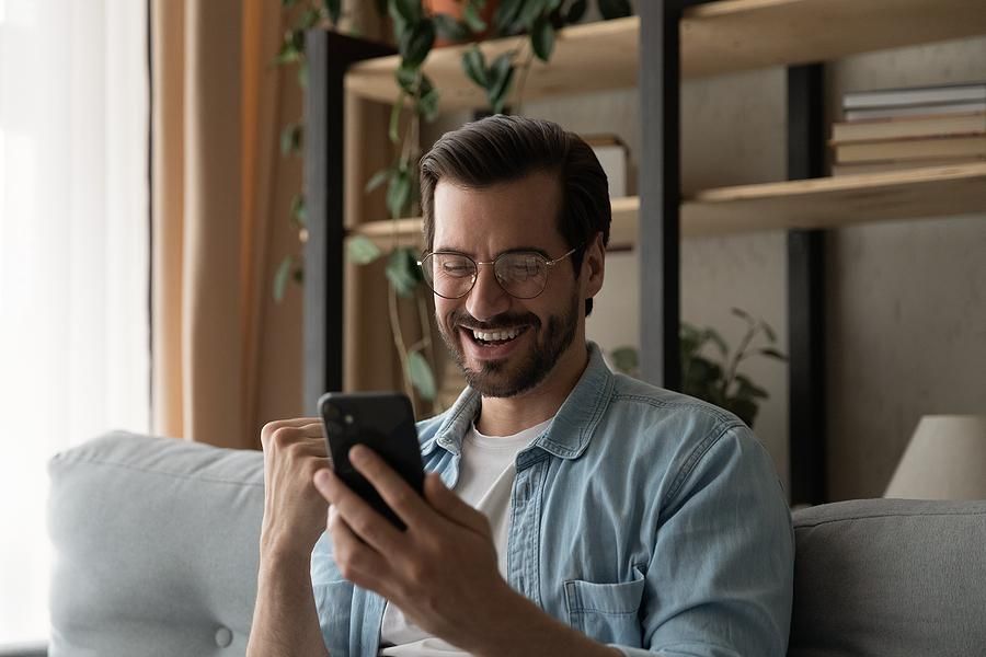 Happy man on phone is excited about receiving a job offer
