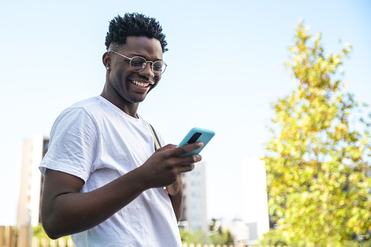 Happy man on phone talks to his career coach at Work It DAILY