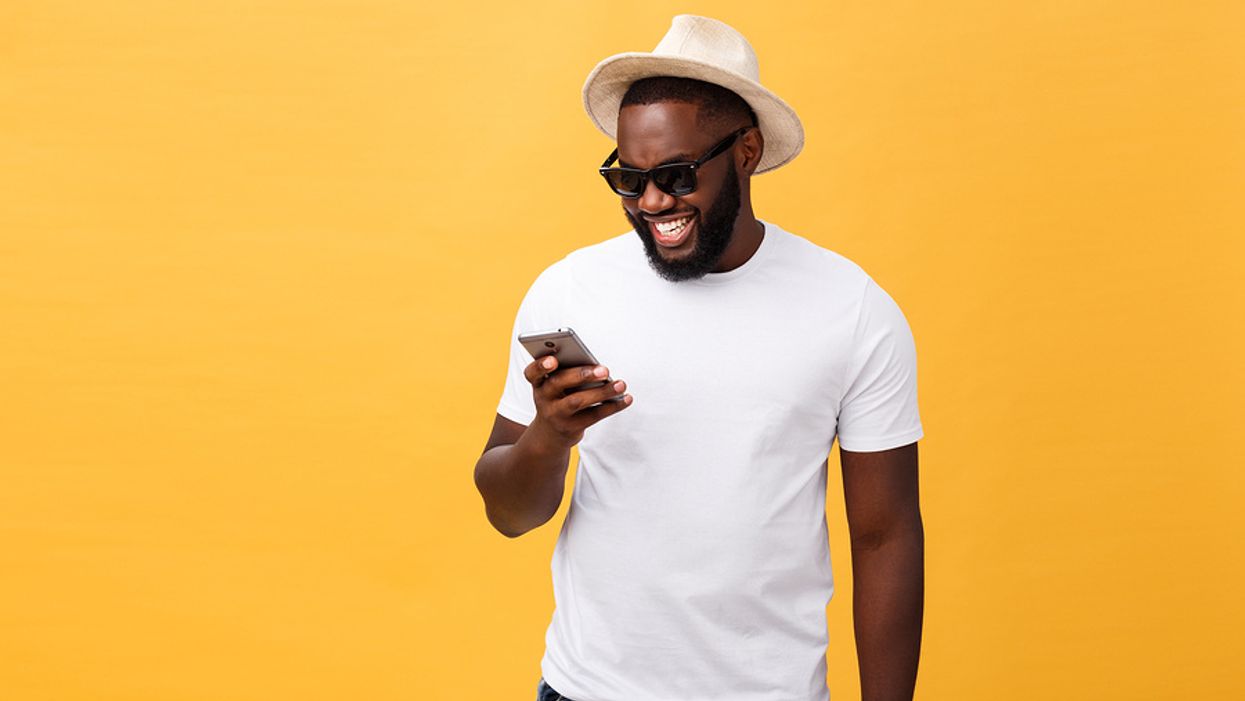 Happy man reading work-life balance quotes on his phone