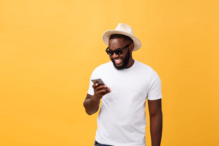 Happy man reading work-life balance quotes on his phone