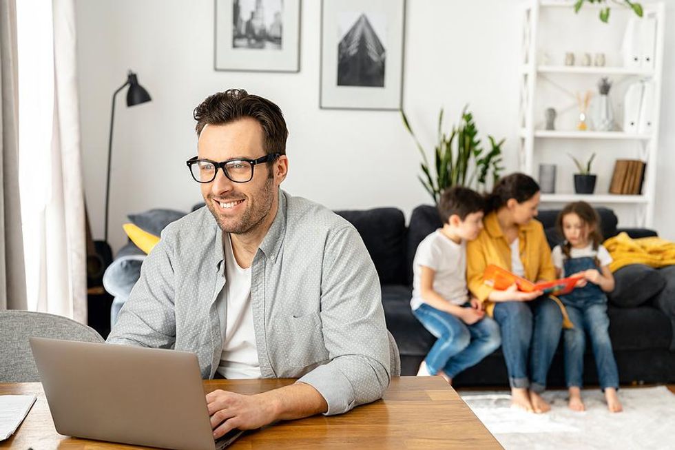 Happy man works his dream job from home