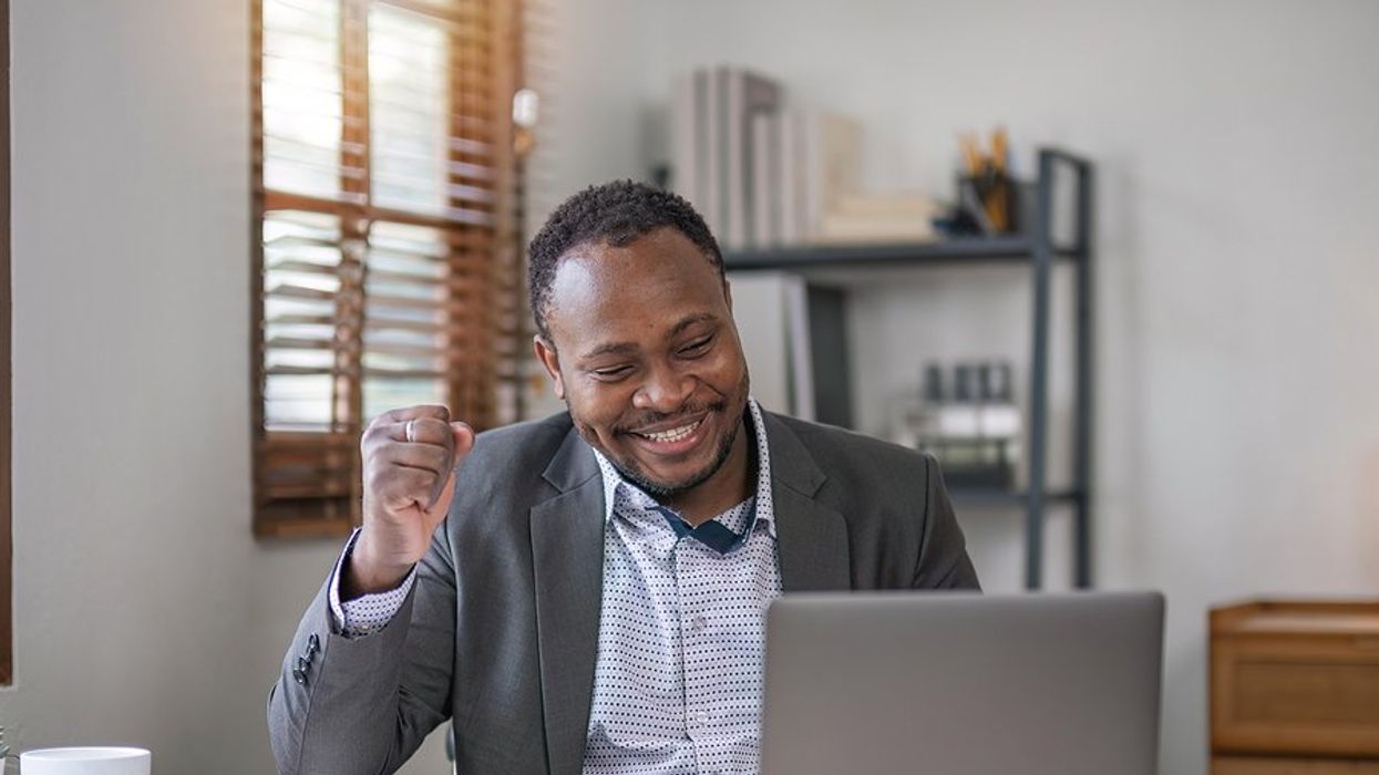 Happy professional man on laptop finds his dream job