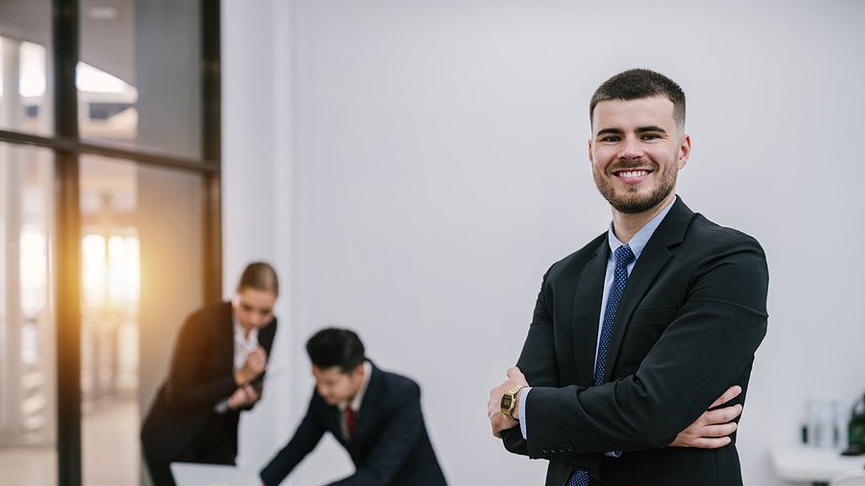 Happy professional man tries to become a better leader at work