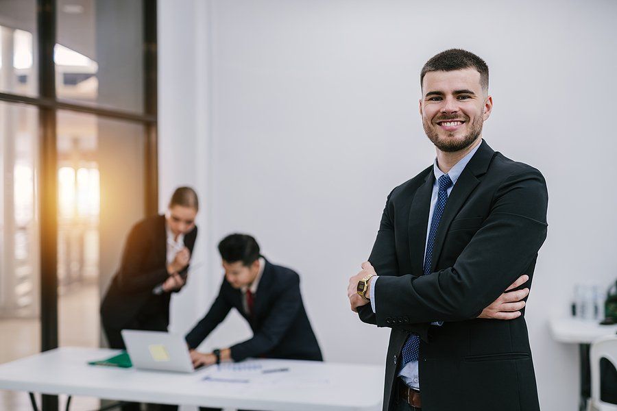 Happy professional man tries to become a better leader at work