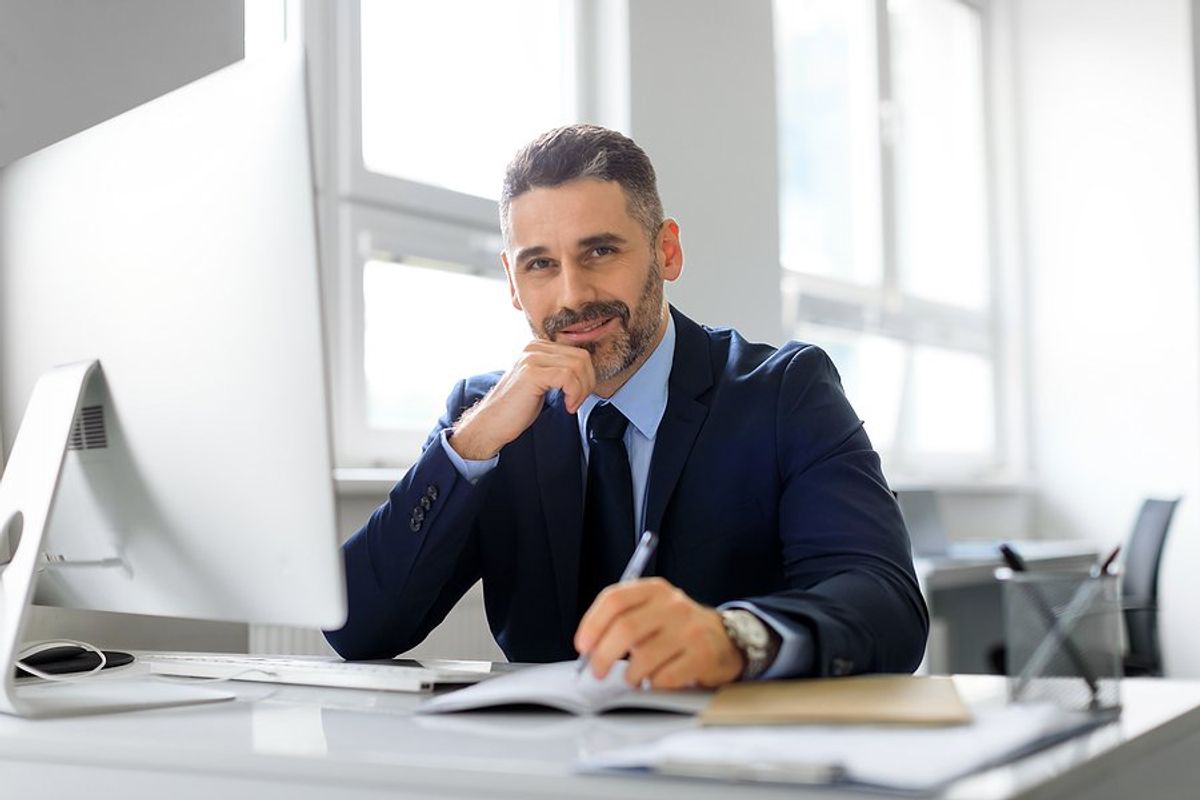 Happy, professional, older man at his new job