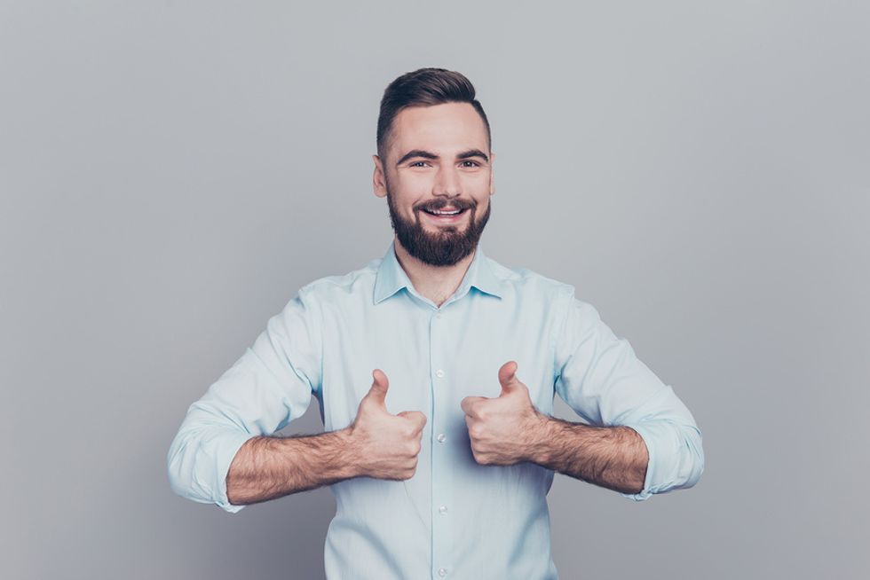 Happy professional with a strong personal brand gives the thumbs up