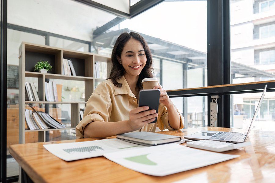 Happy professional woman reads inspirational career quotes on her phone