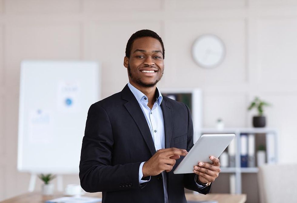 Happy/successful professional man holding a tablet