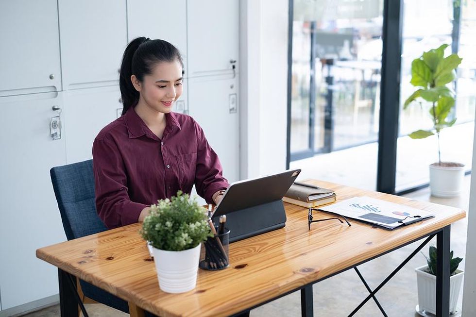 Happy woman at work on a Monday