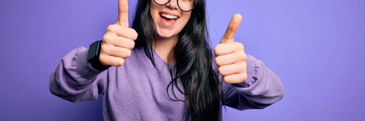 Happy woman knows acts of kindness can improve the mood of those going through career challenges