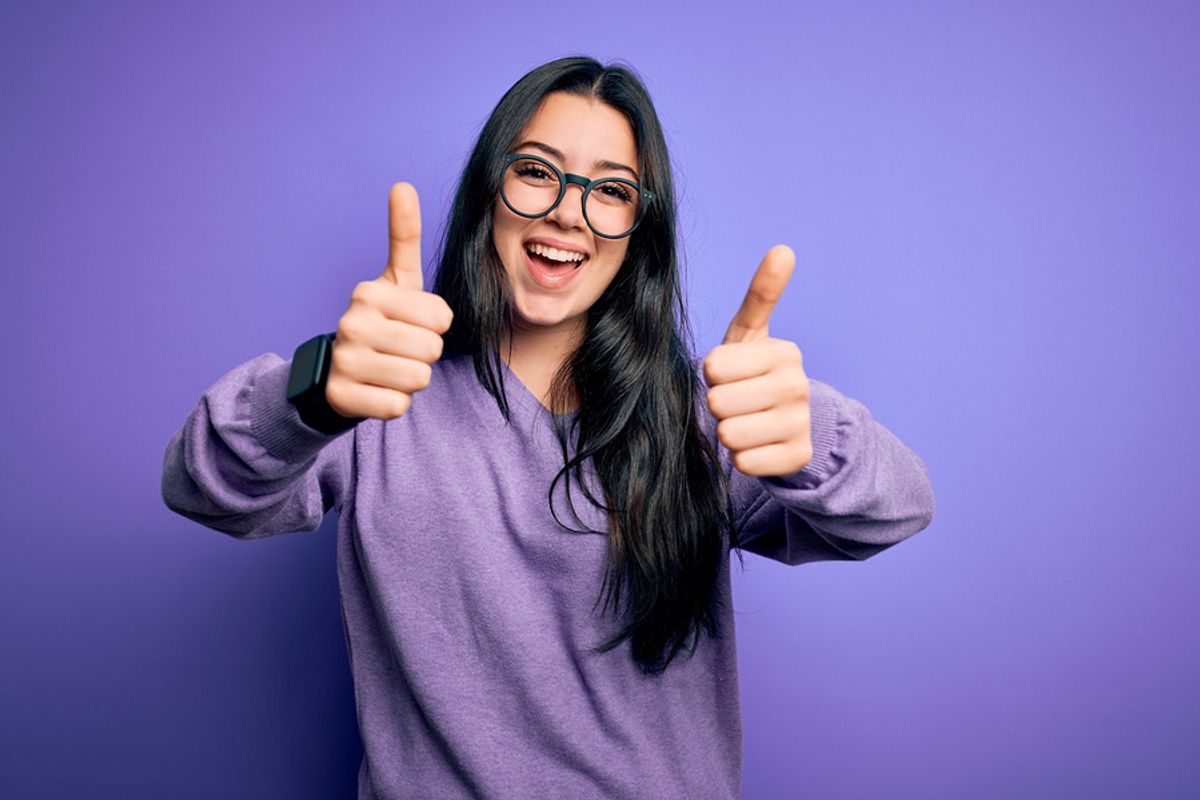 Happy woman knows acts of kindness can improve the mood of those going through career challenges