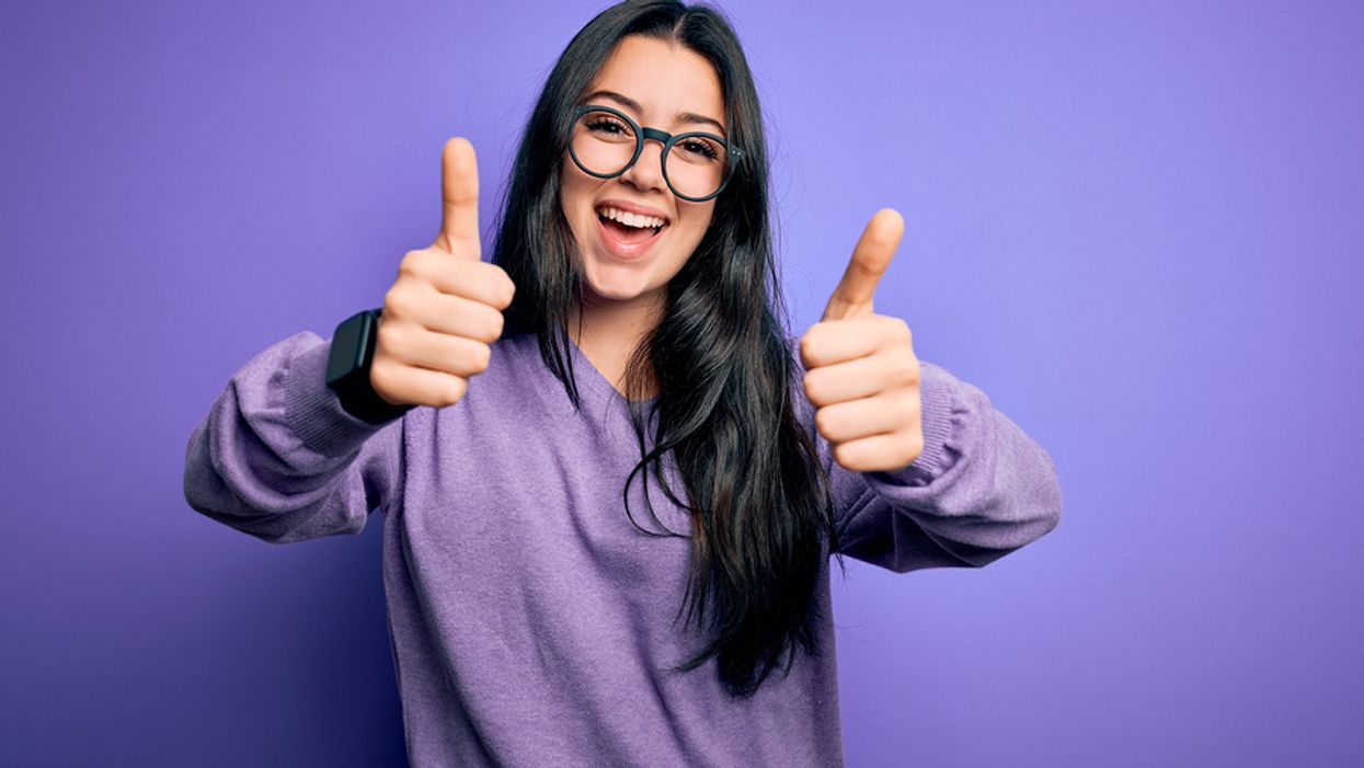 Happy woman knows acts of kindness can improve the mood of those going through career challenges