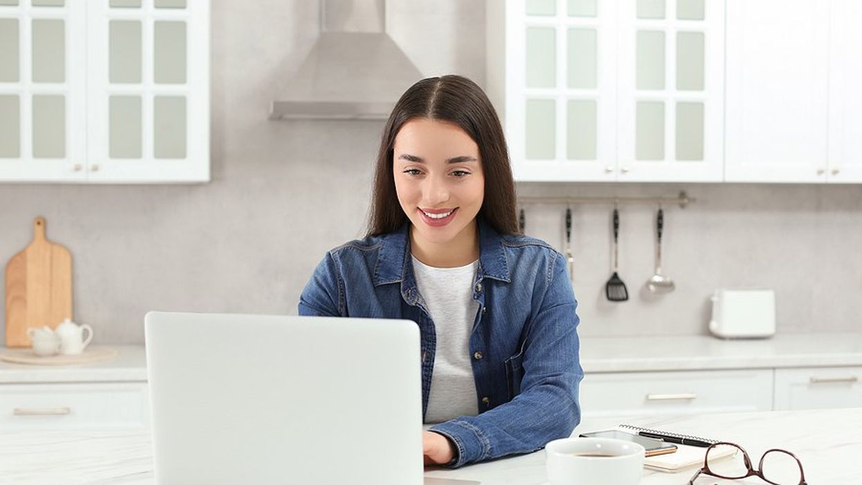 Happy woman laptop follows up on her resume during her job search