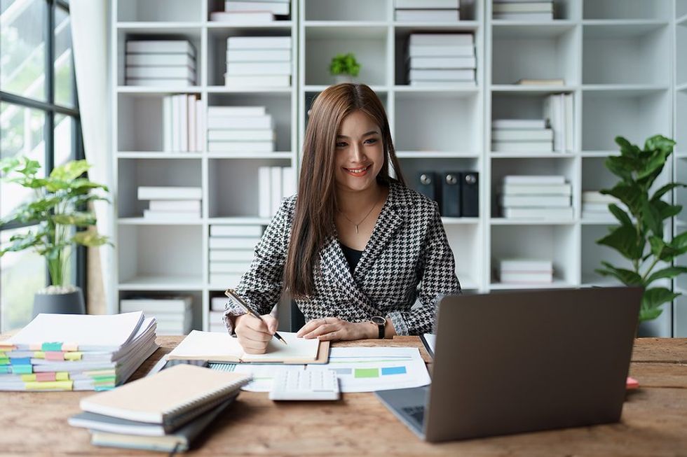 Happy woman on laptop works on the budget