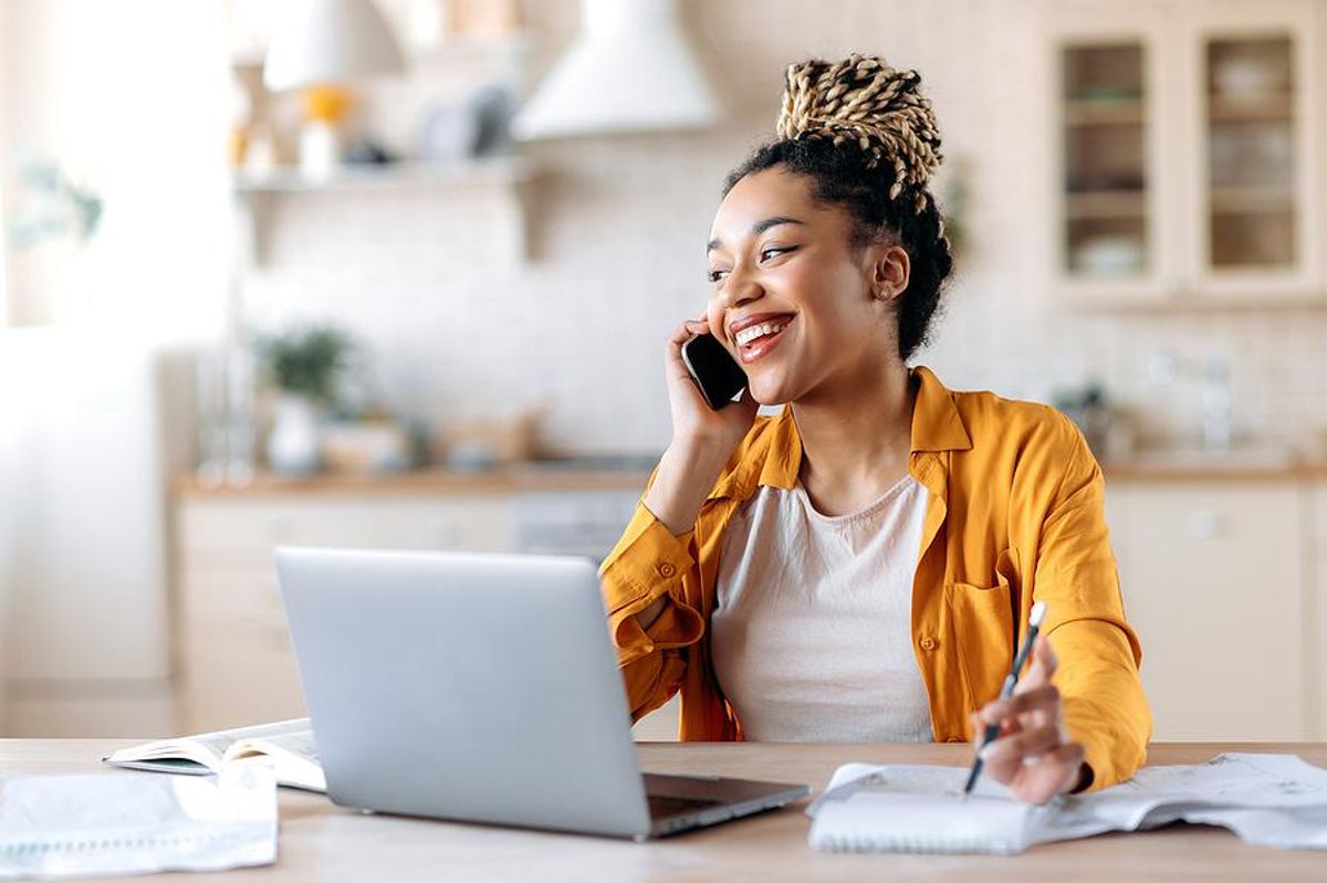 Happy woman on the phone looks for a job