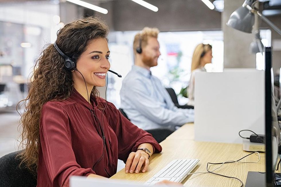 Happy woman sitting at her desk at work