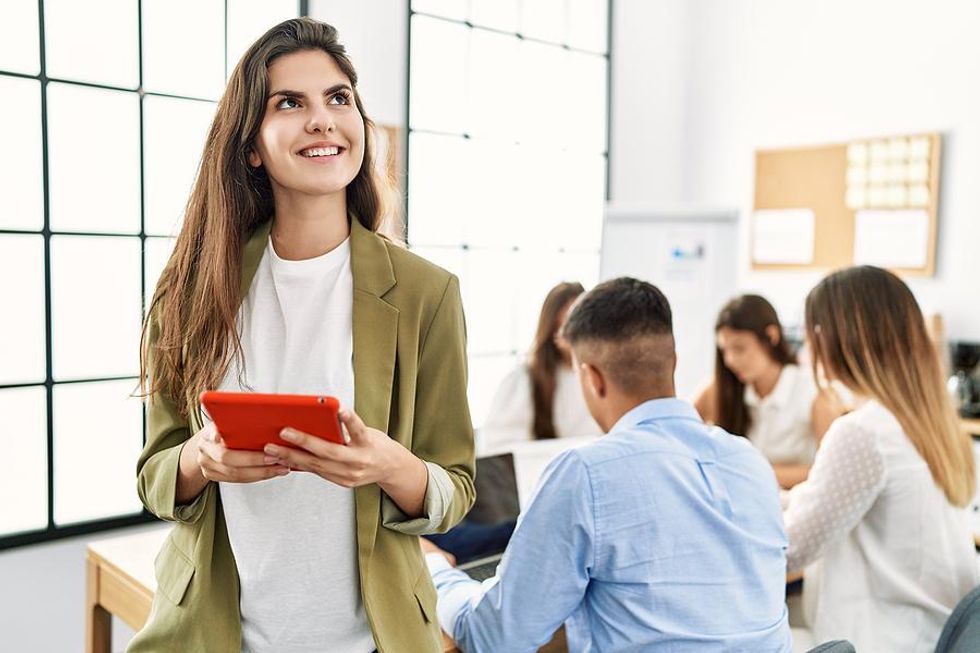 Happy woman thinks about something during a meeting