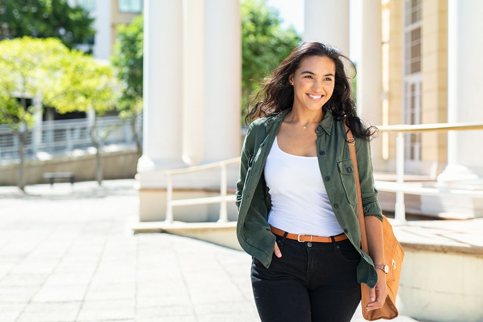 Happy woman walking stays positive after being laid off