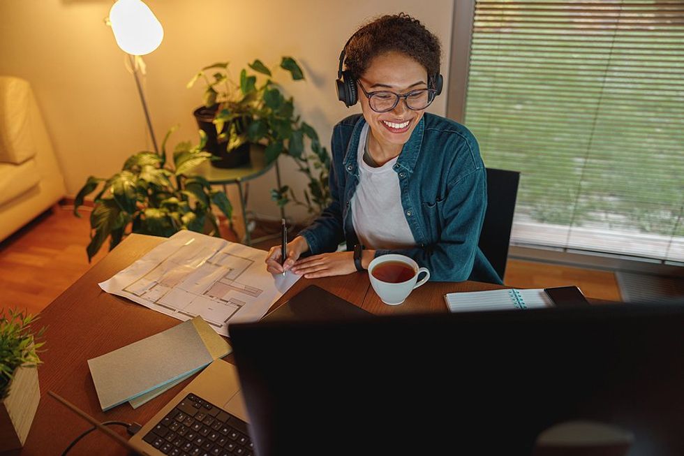 Happy woman works in her home office