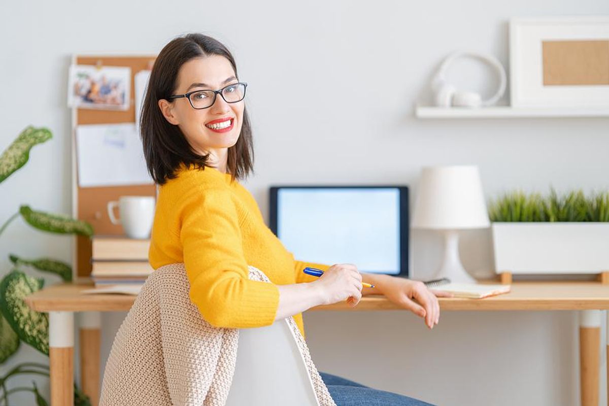 Happy woman writing a career change resume