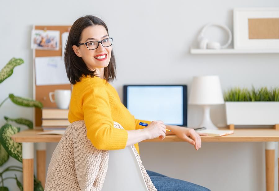 Happy woman writing a career change resume