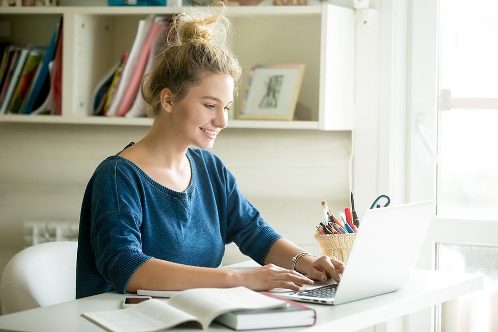 Happy young woman works from home